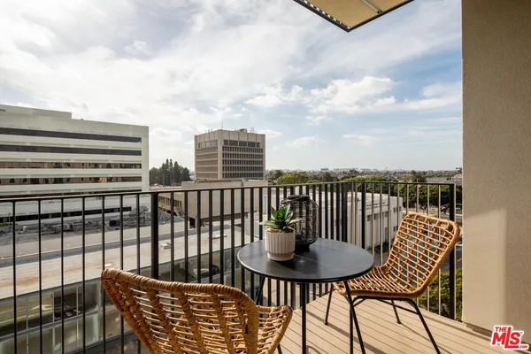 a view of a balcony with two chairs and a table