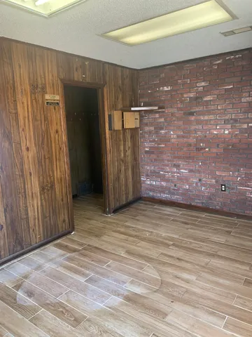 a view of a room with wooden walls