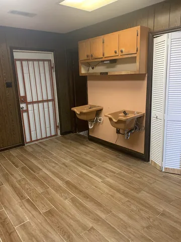 a view of a room with wooden floor and chair