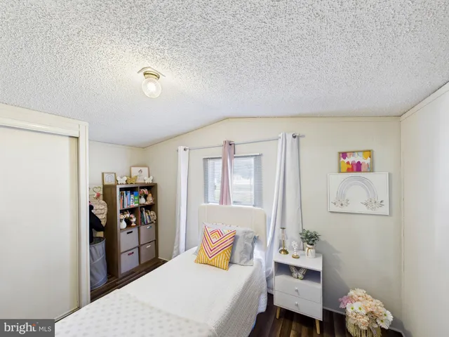 a bedroom with a bed and a book shelf