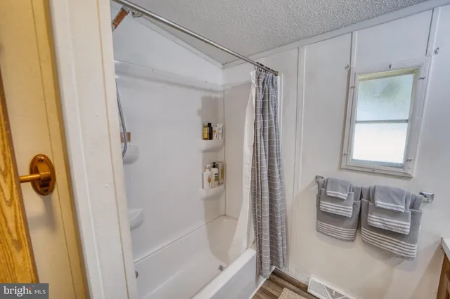 a bathroom with a toilet sink tub and mirror