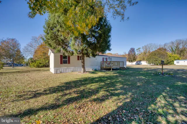 a view of deck with furniture and trees
