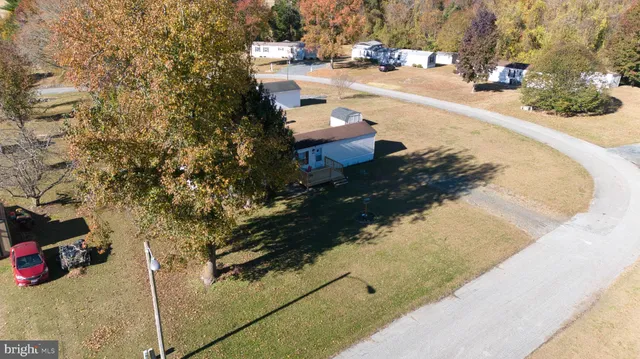 an aerial view of a house with swimming pool and mountain view