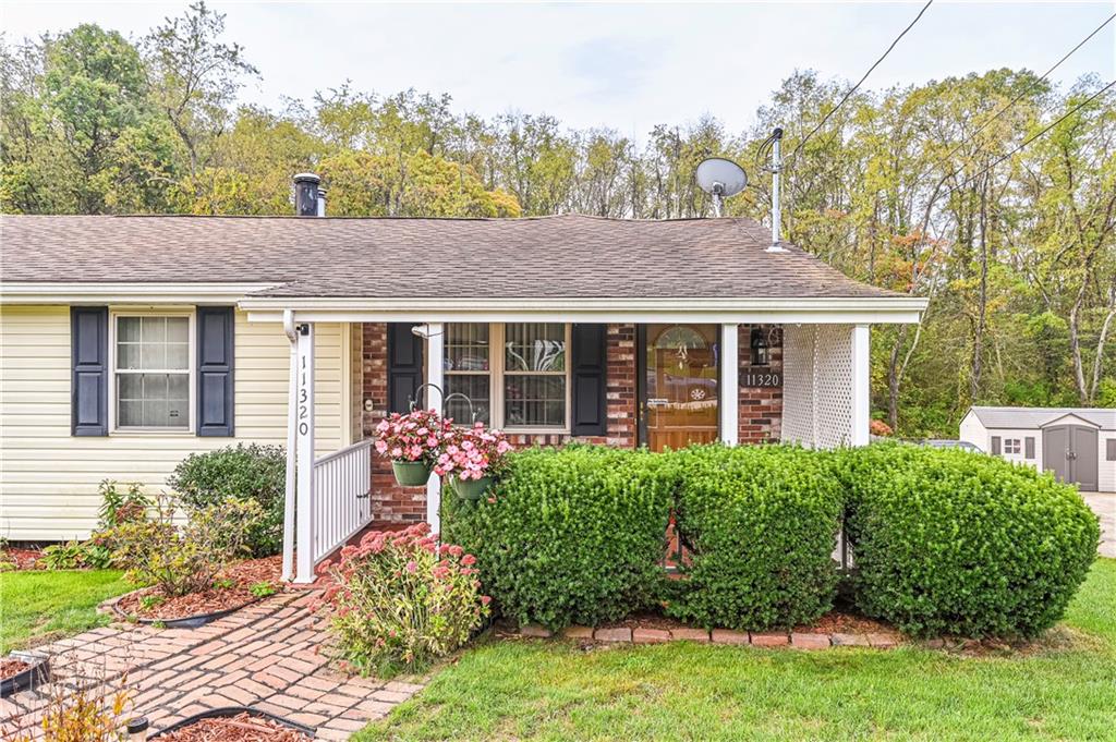 11320 James Street Irwin, PA 15642 - Photo 2 of 42 a front view of a house with garden