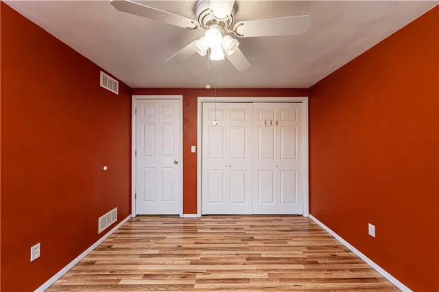 a view of a livingroom with a chandelier fan and a ceiling fan