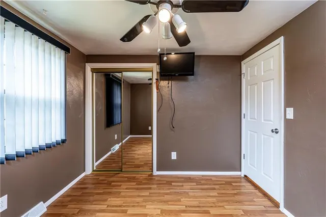 a view of a livingroom with wooden floor and chandelier