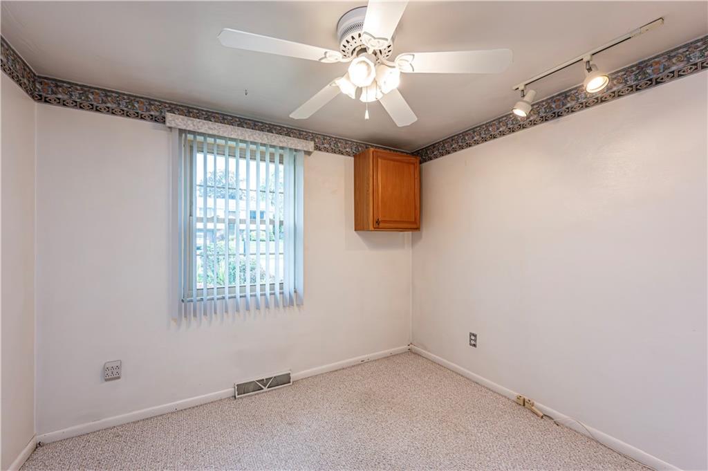 11320 James Street Irwin, PA 15642 - Photo 27 of 42 a view of a livingroom with a ceiling fan and window