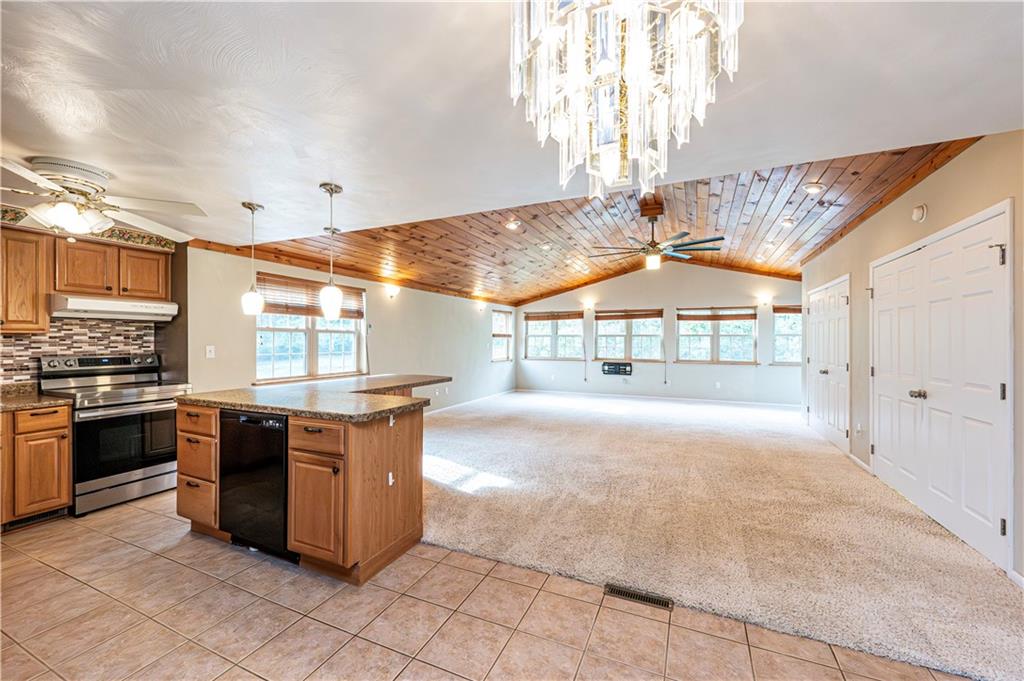 11320 James Street Irwin, PA 15642 - Photo 4 of 42 a large kitchen with stainless steel appliances granite countertop a stove and cabinets