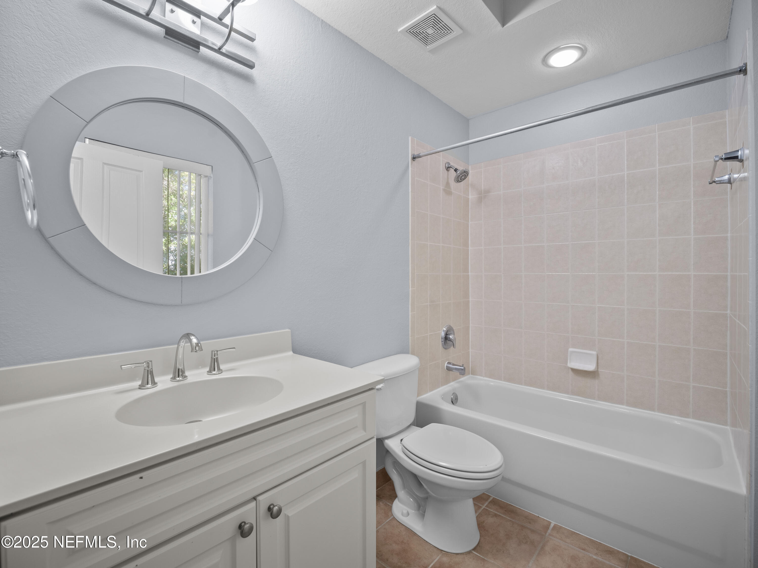 9745 Touchton Road, Unit 1204 Jacksonville, FL 32246 - Photo 11 of 35 a bathroom with a toilet a sink and a mirror