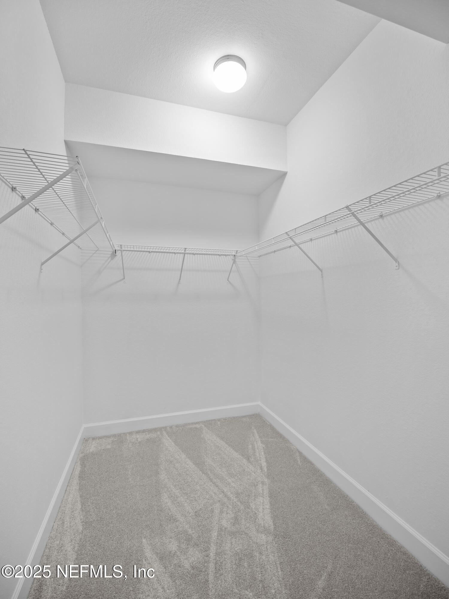 9745 Touchton Road, Unit 1204 Jacksonville, FL 32246 - Photo 12 of 35 a view of a room with racks on the wall