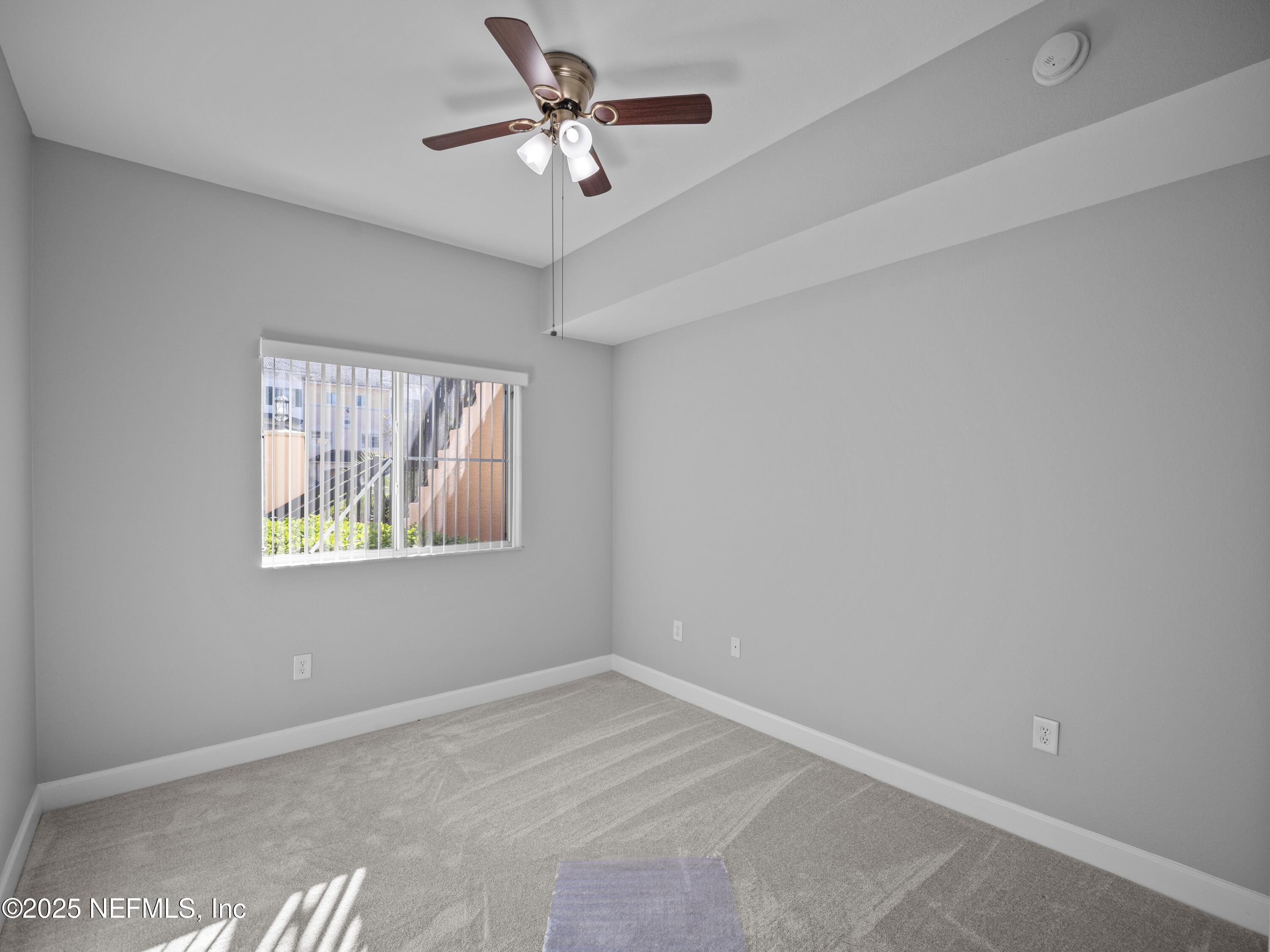9745 Touchton Road, Unit 1204 Jacksonville, FL 32246 - Photo 13 of 35 an empty room with windows and fan