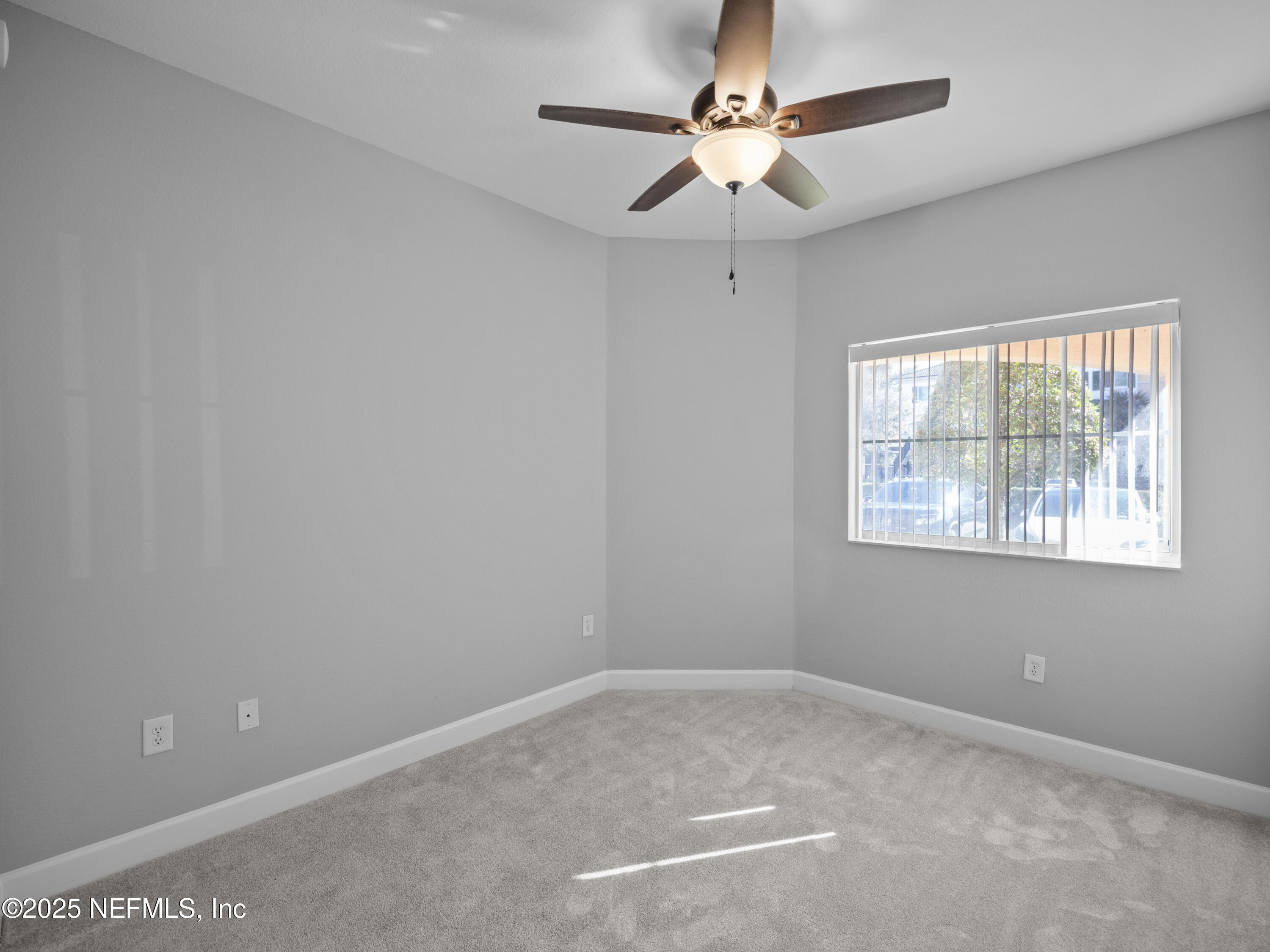 9745 Touchton Road, Unit 1204 Jacksonville, FL 32246 - Photo 15 of 35 an empty room with a window and a fan