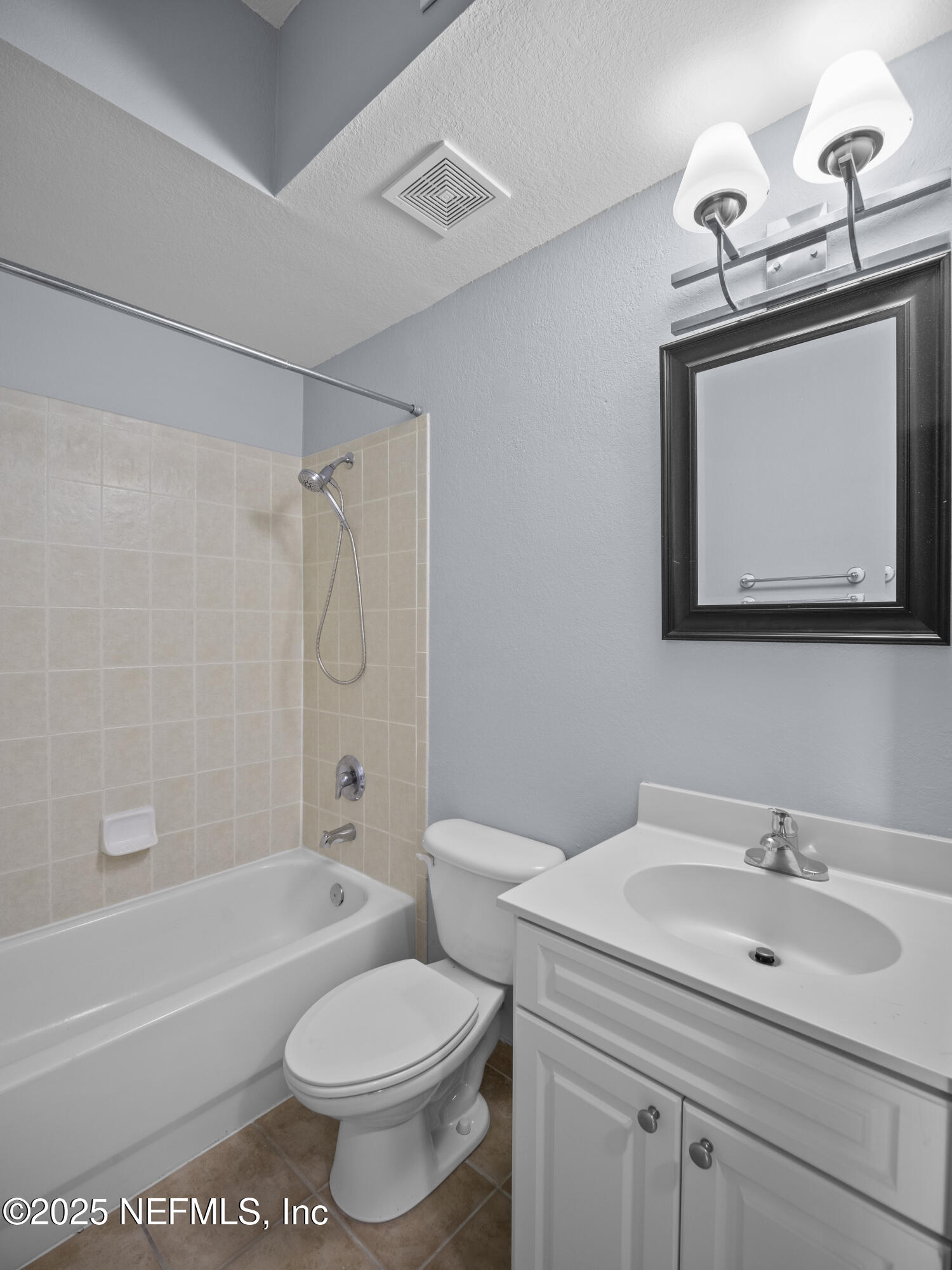 9745 Touchton Road, Unit 1204 Jacksonville, FL 32246 - Photo 17 of 35 a bathroom with a sink toilet and shower