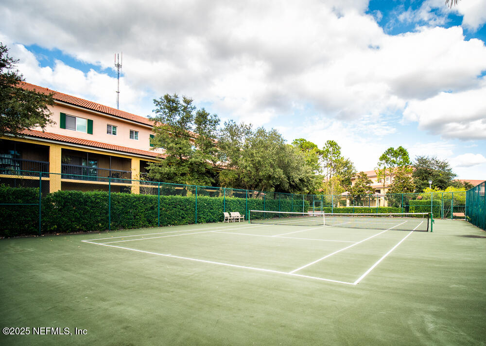 9745 Touchton Road, Unit 1204 Jacksonville, FL 32246 - Photo 28 of 35 a view of a tennis ground with large trees