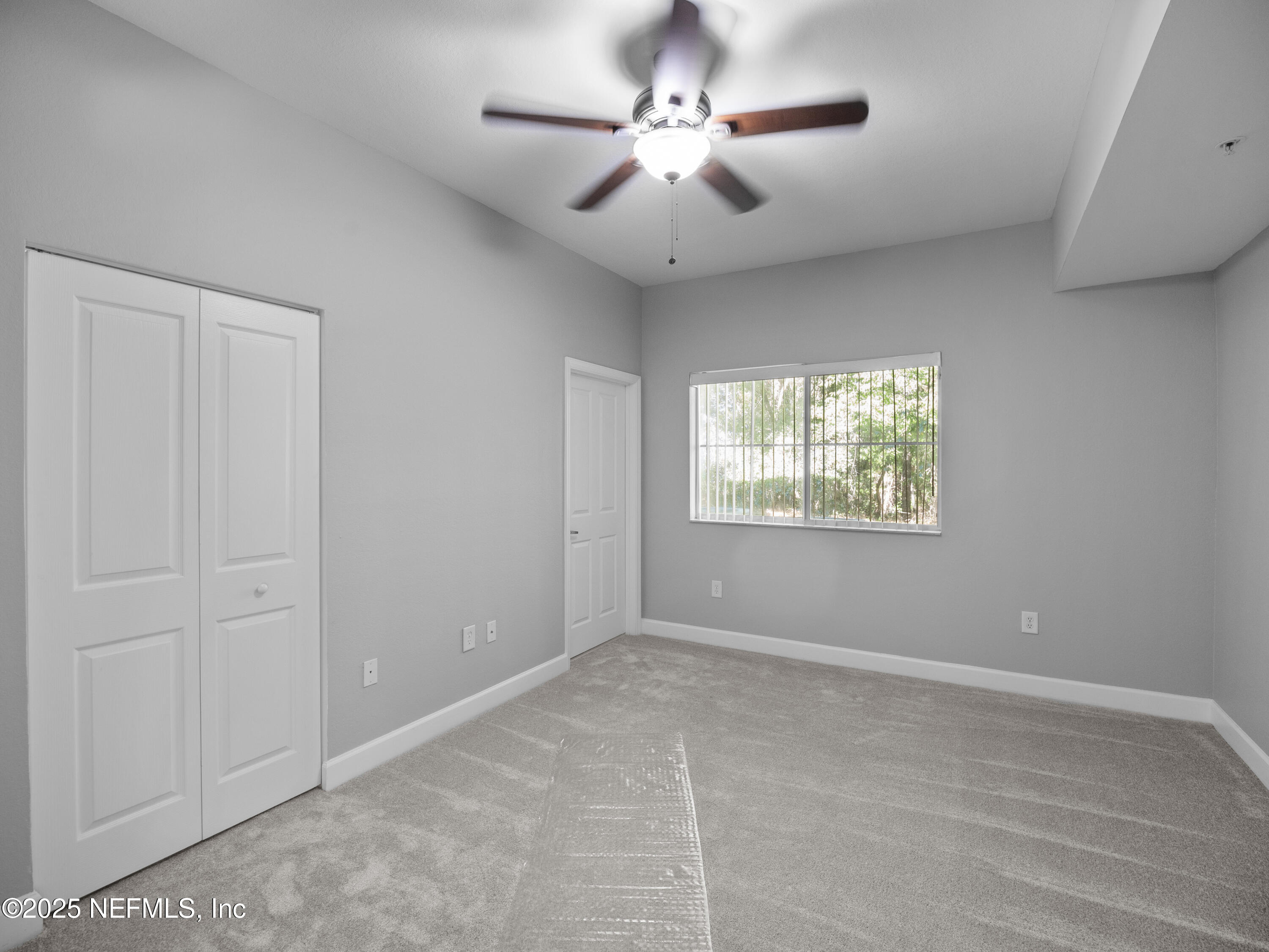 9745 Touchton Road, Unit 1204 Jacksonville, FL 32246 - Photo 9 of 35 a view of an empty room with a window