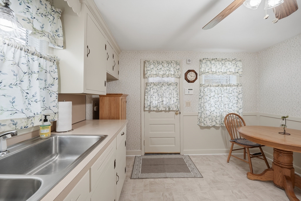 246 El Paso Street Springfield, MA 01104 - Photo 5 of 29 a kitchen with stainless steel appliances granite countertop a sink and a granite counter tops with white cabinets