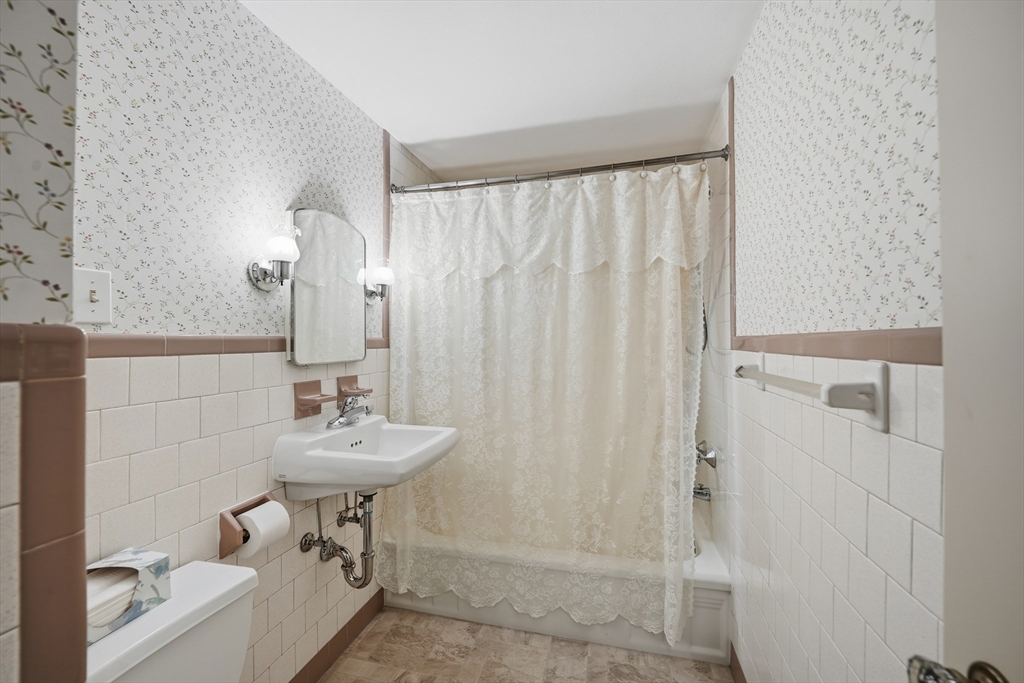 246 El Paso Street Springfield, MA 01104 - Photo 7 of 29 a bathroom with a sink a toilet and a mirror