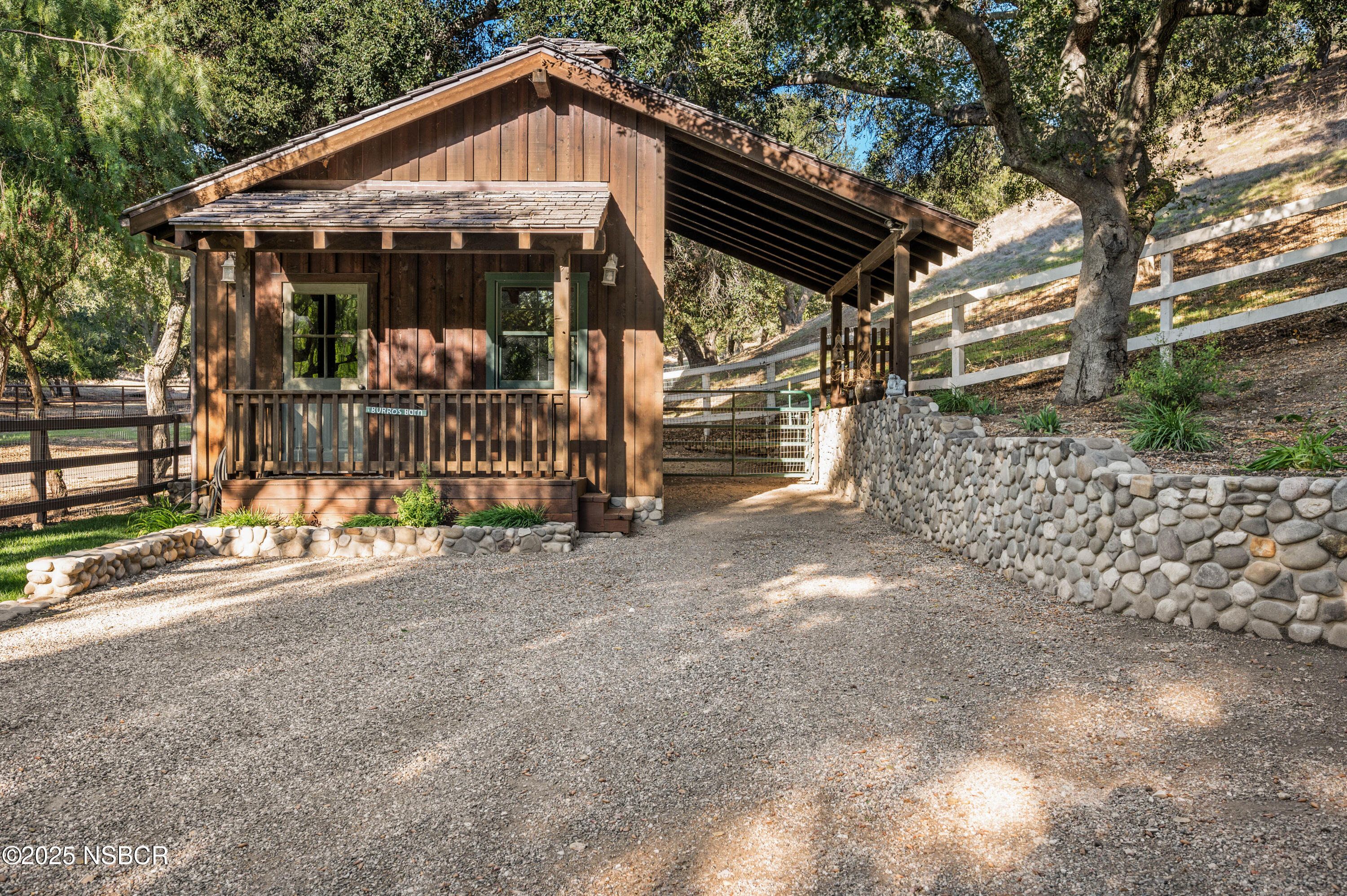 4086 East Oak Trail Road Santa Ynez, CA 93460 - Photo 41 of 57 a view of a small house with a small yard and wooden fence