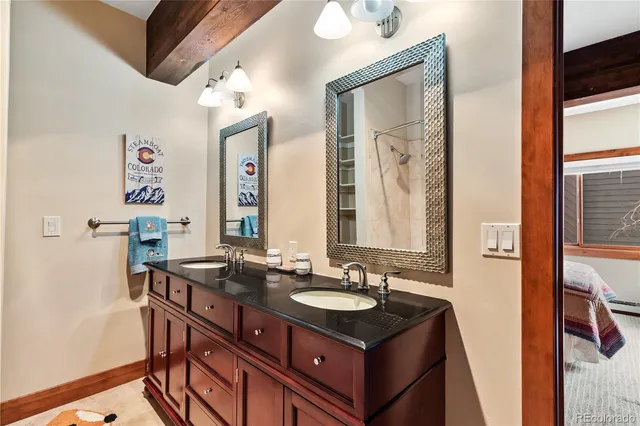 a bathroom with a sink vanity and a mirror