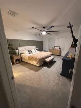 a living room with furniture a flat screen tv and a table