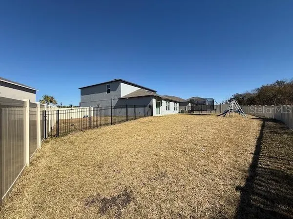 a view of a backyard of the house