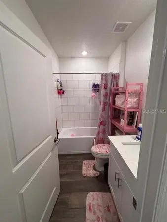 a bedroom with a bed and a television