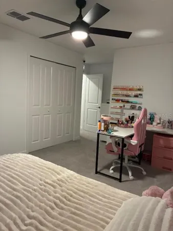 a bed sitting in a bedroom and table