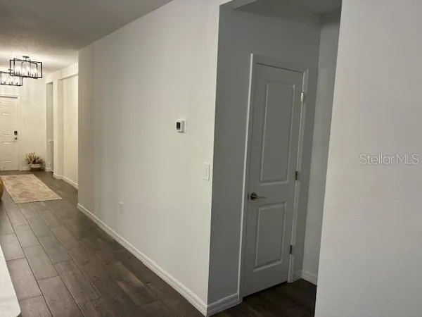 a kitchen with stainless steel appliances granite countertop a sink a stove and chairs