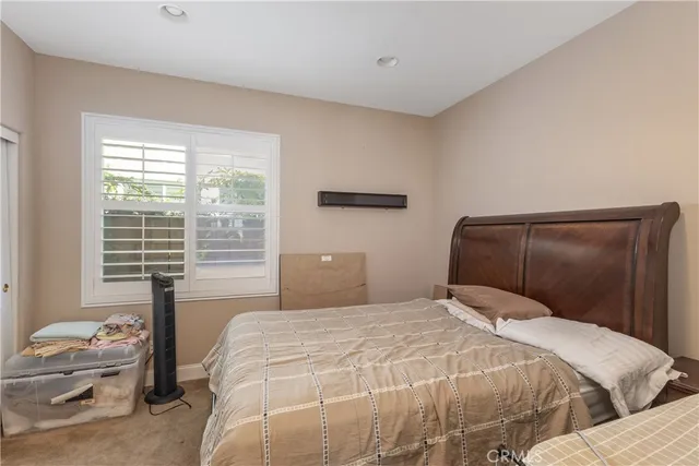 a bedroom with a bed and window