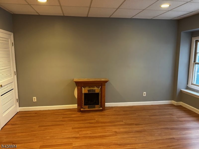 45 Halsey Street Newark, NJ 07102 - Photo 3 of 7 a view of an empty room with wooden floor and a window