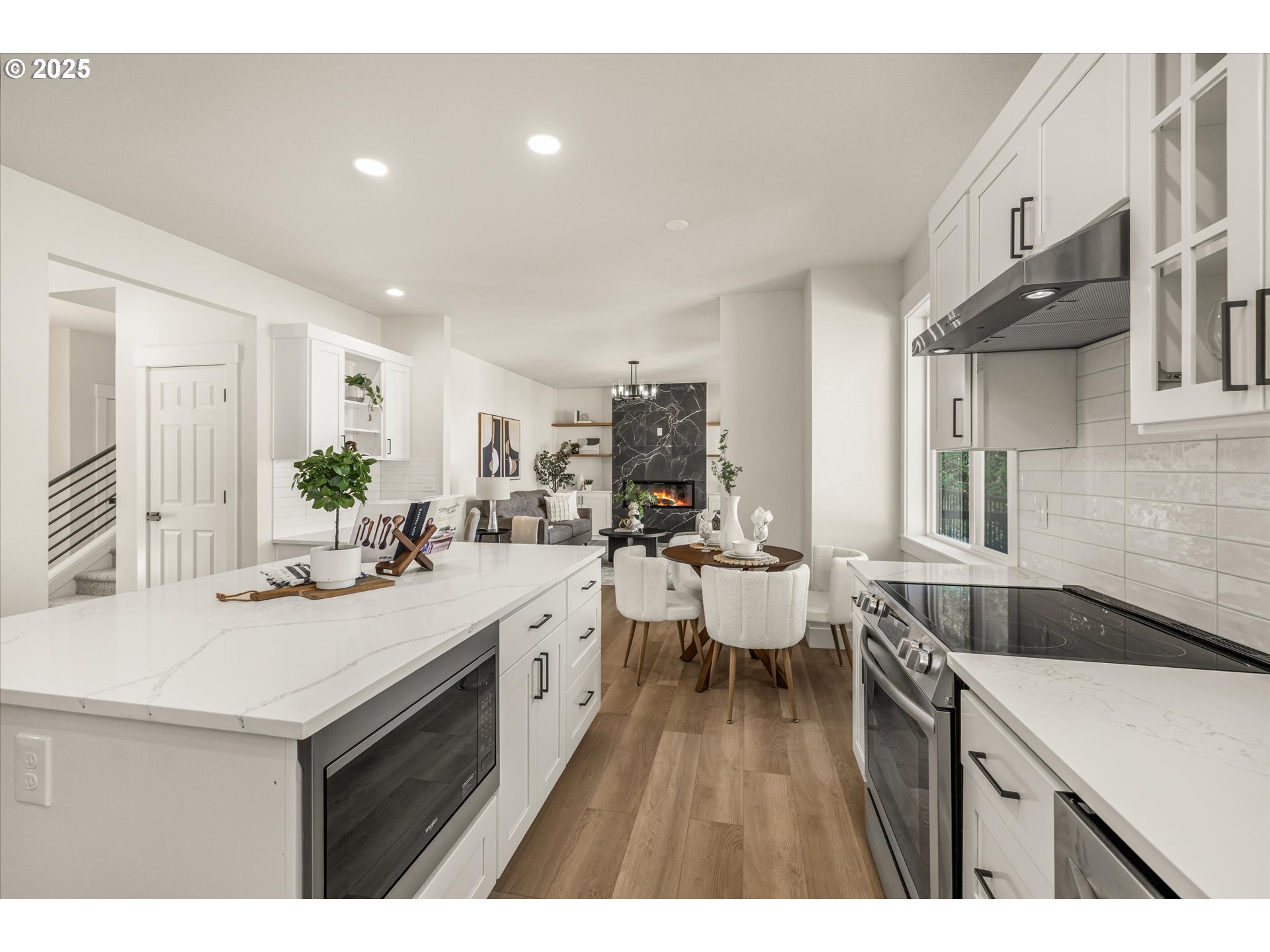 7026 Southeast 156th Avenue Portland, OR 97236 - Photo 12 of 48 a kitchen with a sink and white cabinets with wooden floor