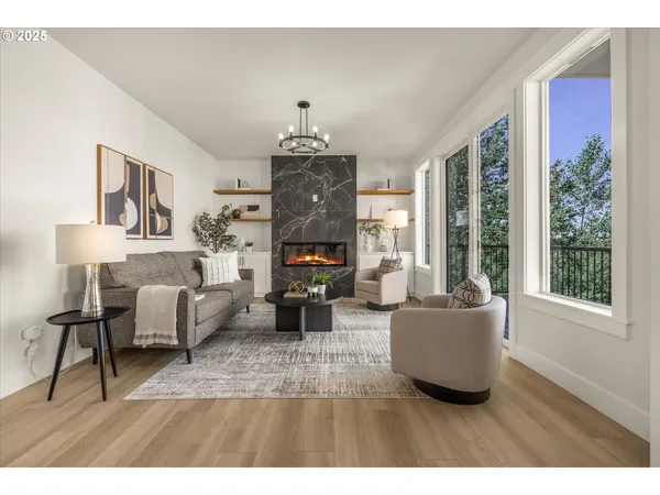 a living room with furniture a fireplace and a large window