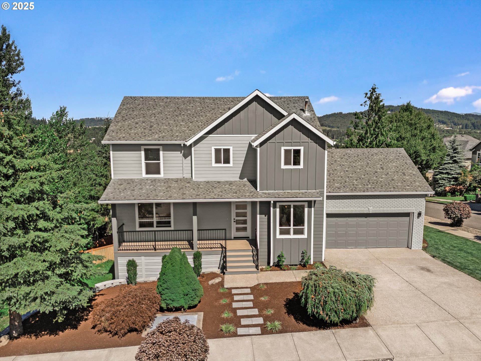 7026 Southeast 156th Avenue Portland, OR 97236 - Photo 2 of 48 a front view of a house with a yard and garage