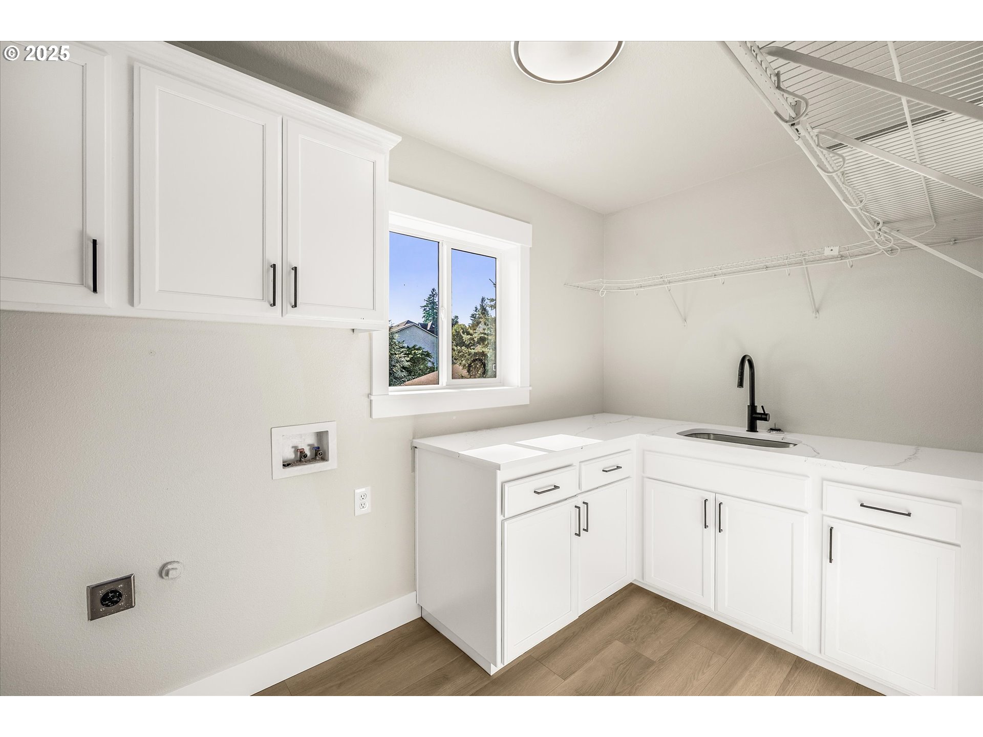 7026 Southeast 156th Avenue Portland, OR 97236 - Photo 29 of 48 a kitchen with a sink dishwasher and white cabinets