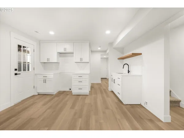 a room with stainless steel appliances wooden floors and view living room