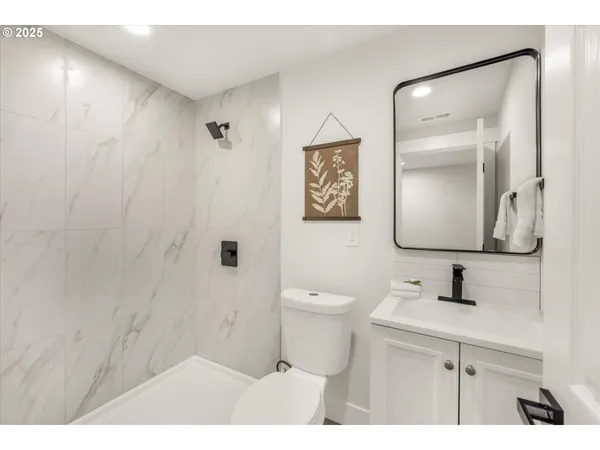 a bathroom with a sink mirror toilet and vanity