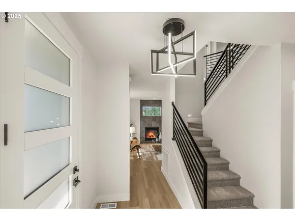 a view of entryway and hall with wooden floor