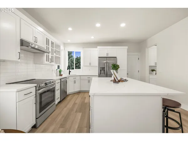 a kitchen with a sink appliances and cabinets