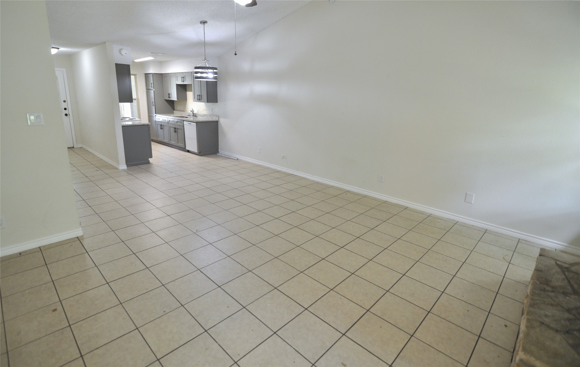 8809 Piney Point Drive, Unit B Austin, TX 78729 - Photo 6 of 10 A tiled floor extends through this open concept living space, leading to a functional kitchen.