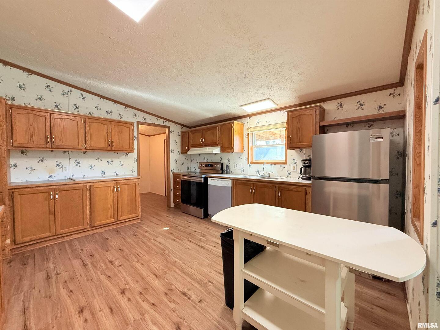 125 Beech Hollow Road Harrisburg, IL 62946 - Photo 25 of 33 a kitchen with stainless steel appliances a refrigerator and wooden cabinets