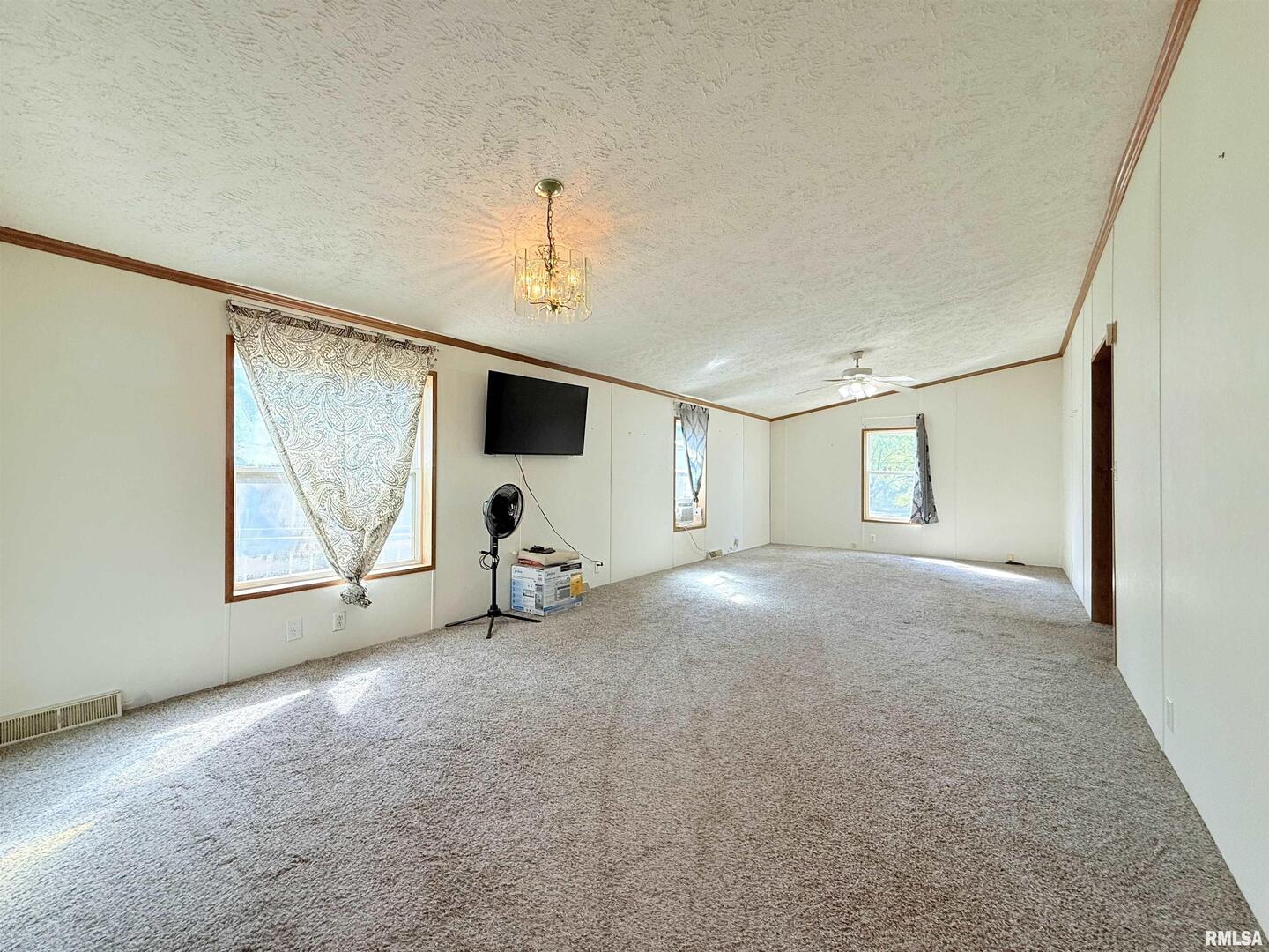 125 Beech Hollow Road Harrisburg, IL 62946 - Photo 27 of 33 a view of a livingroom with a ceiling fan and window