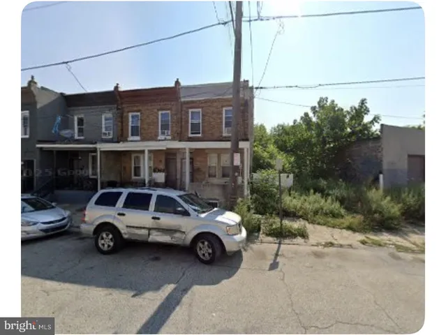 a view of a car parked in front of a house