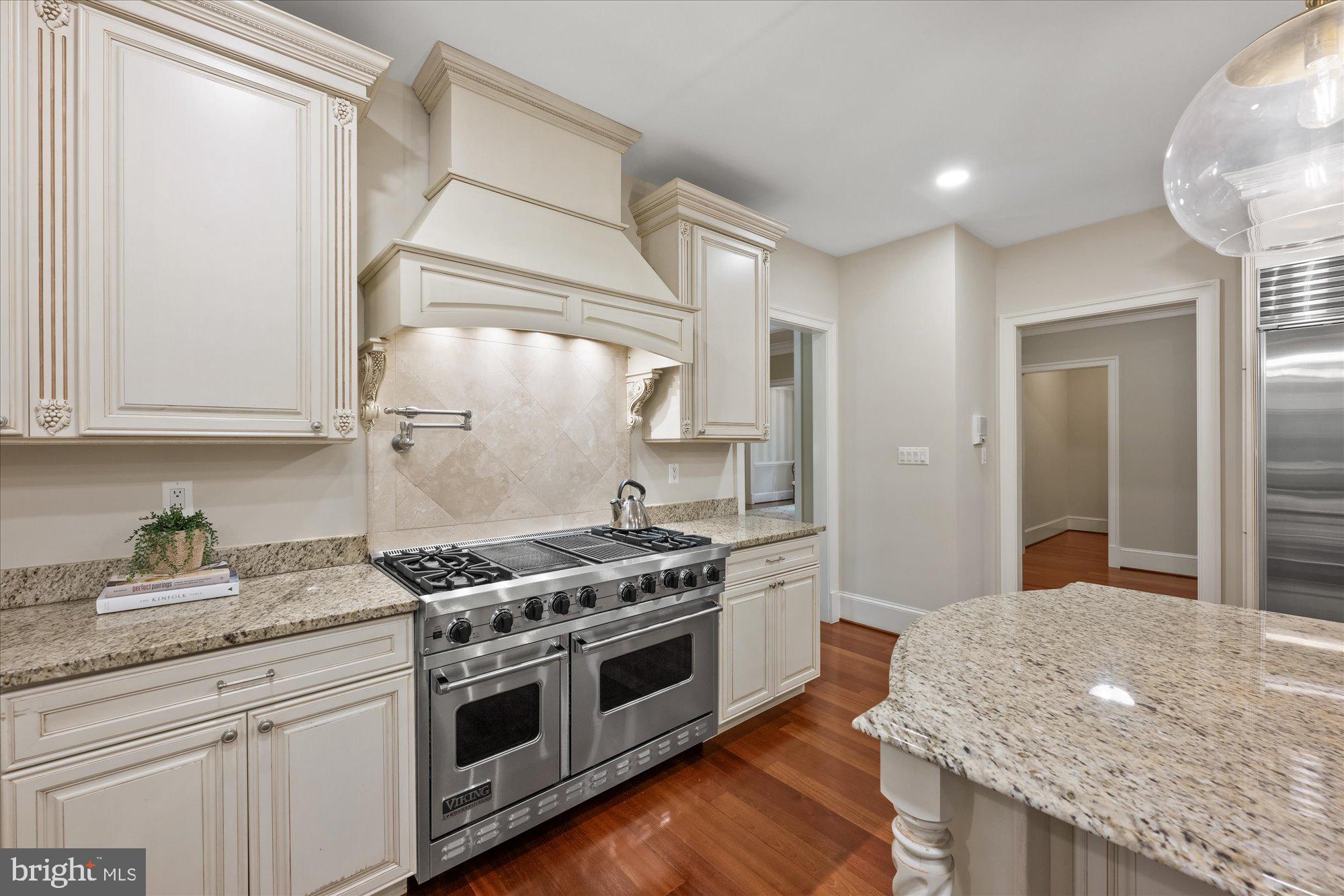 11512 Morning Ride Drive Potomac, MD 20854 - Photo 17 of 51 a kitchen with stainless steel appliances granite countertop a stove and a sink