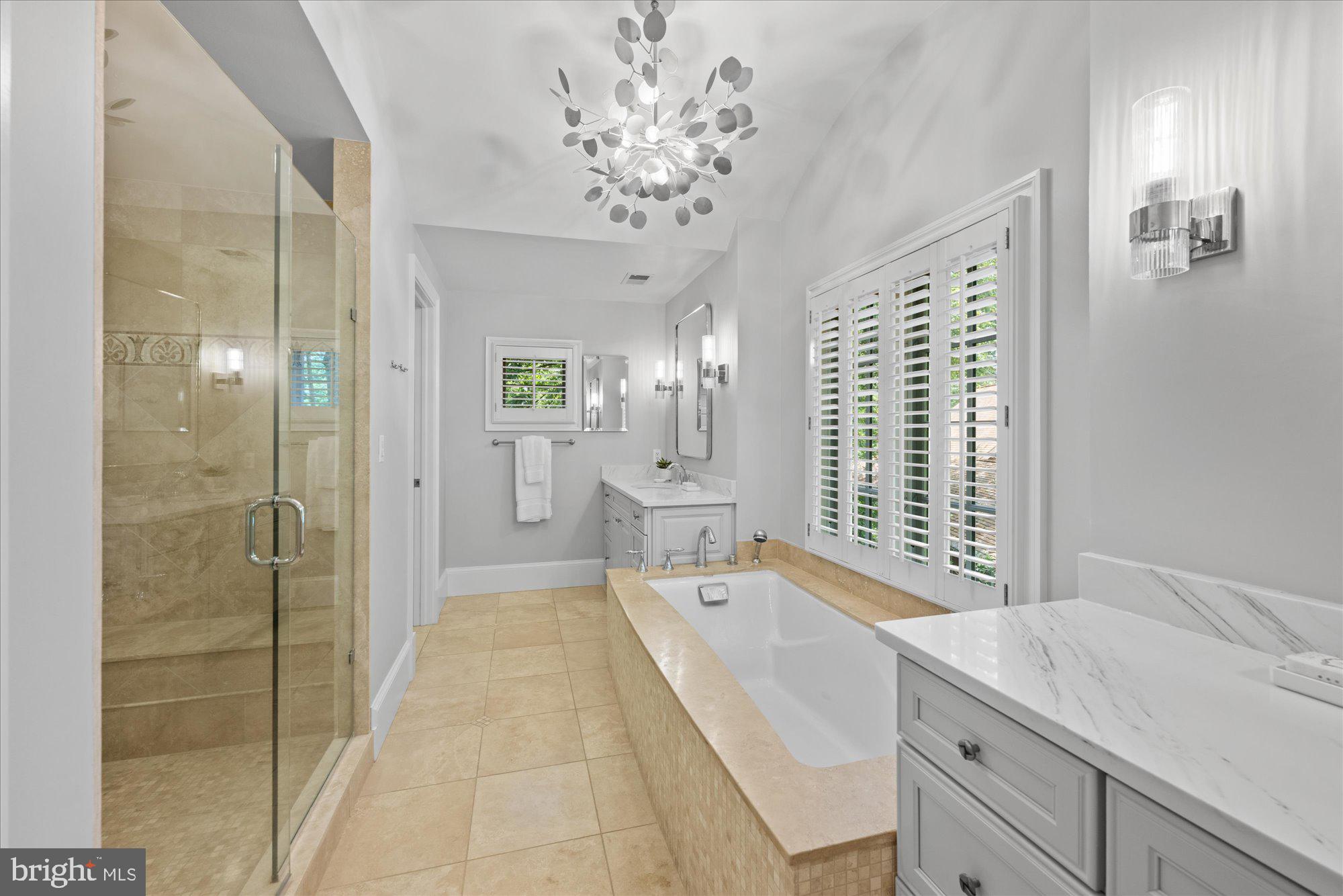 11512 Morning Ride Drive Potomac, MD 20854 - Photo 28 of 51 a spacious bathroom with a shower a sink and a mirror