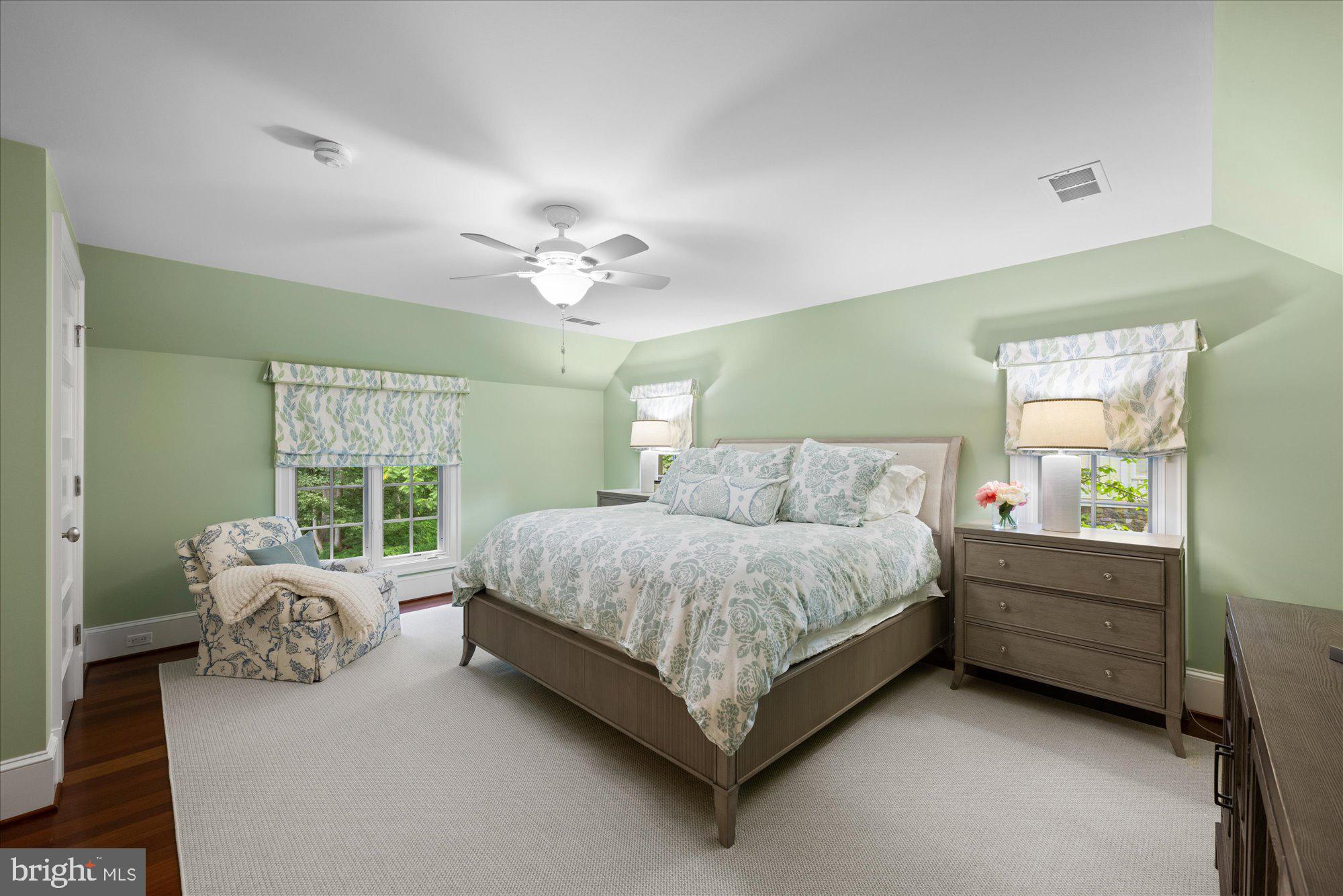 11512 Morning Ride Drive Potomac, MD 20854 - Photo 32 of 51 a spacious bedroom with a bed and a chandelier