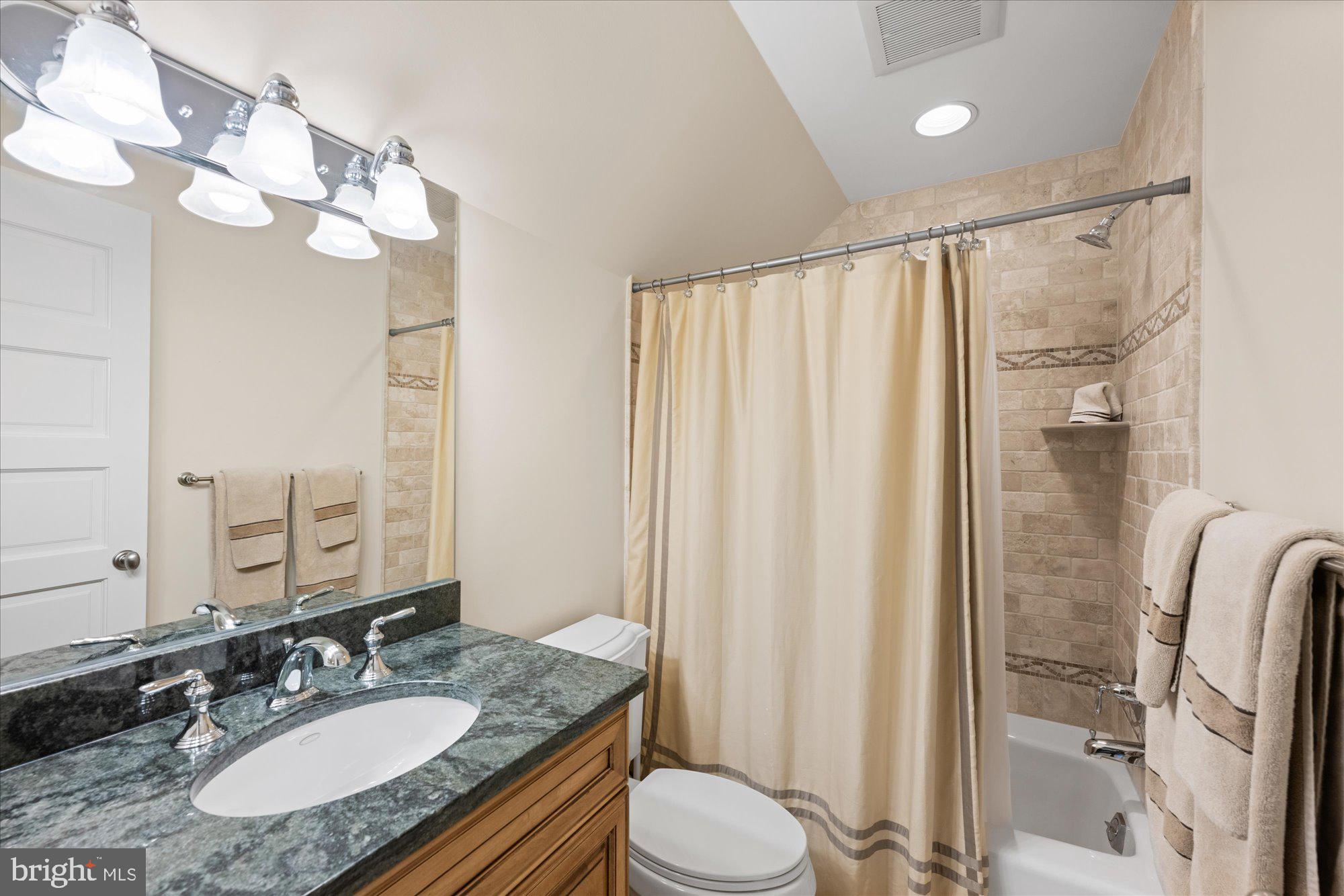 11512 Morning Ride Drive Potomac, MD 20854 - Photo 33 of 51 a bathroom with a granite countertop sink toilet a mirror a vanity and shower