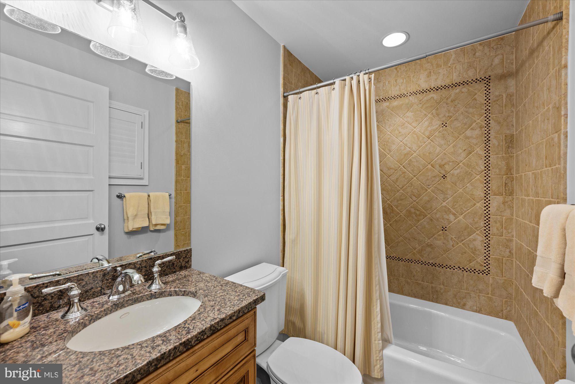 11512 Morning Ride Drive Potomac, MD 20854 - Photo 37 of 51 a bathroom with a granite countertop sink toilet and shower