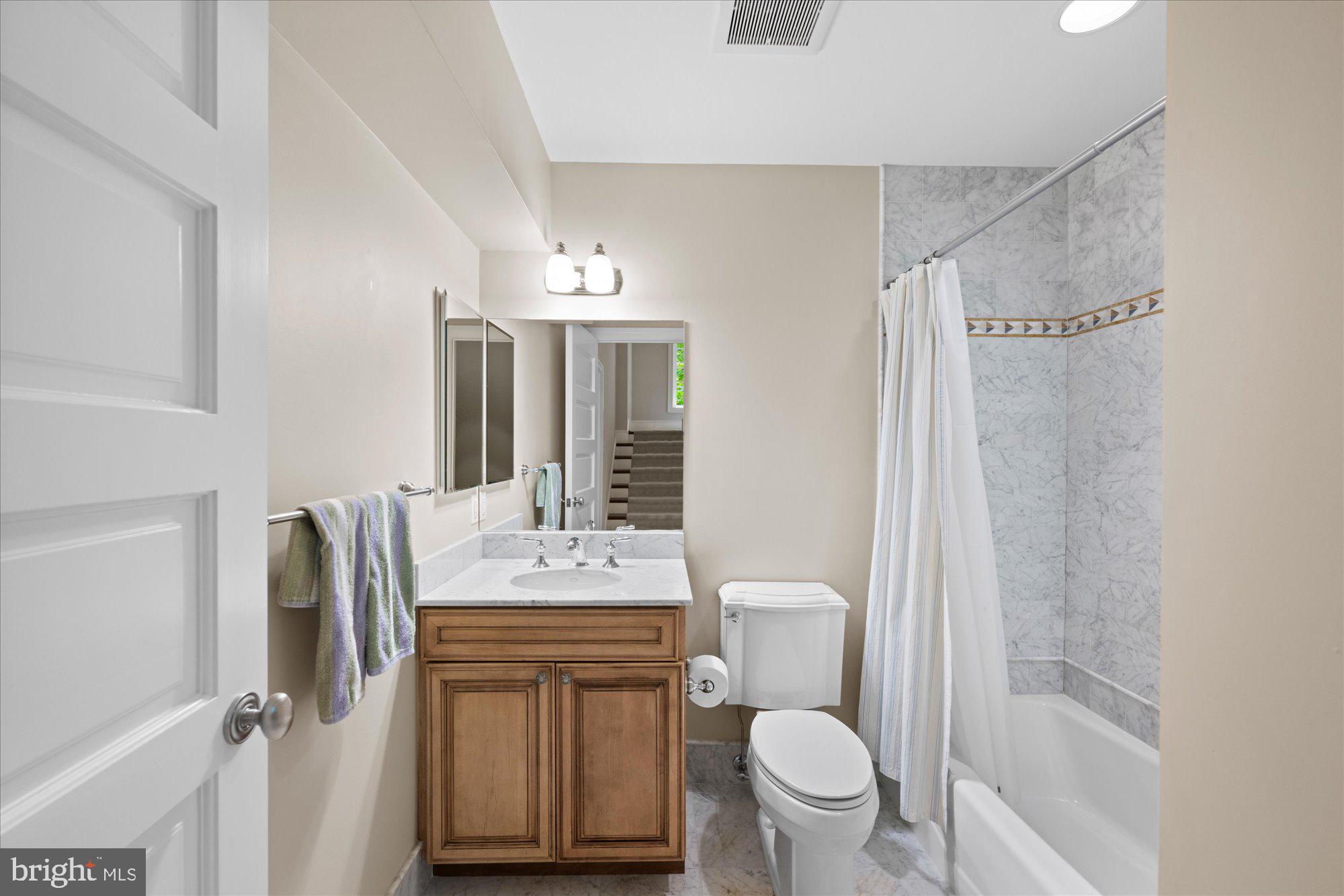 11512 Morning Ride Drive Potomac, MD 20854 - Photo 45 of 51 a bathroom with a sink toilet vanity and shower