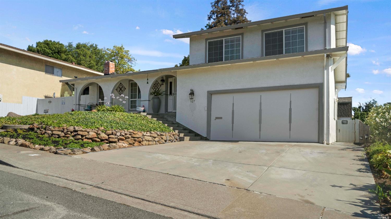 a front view of a house with garden