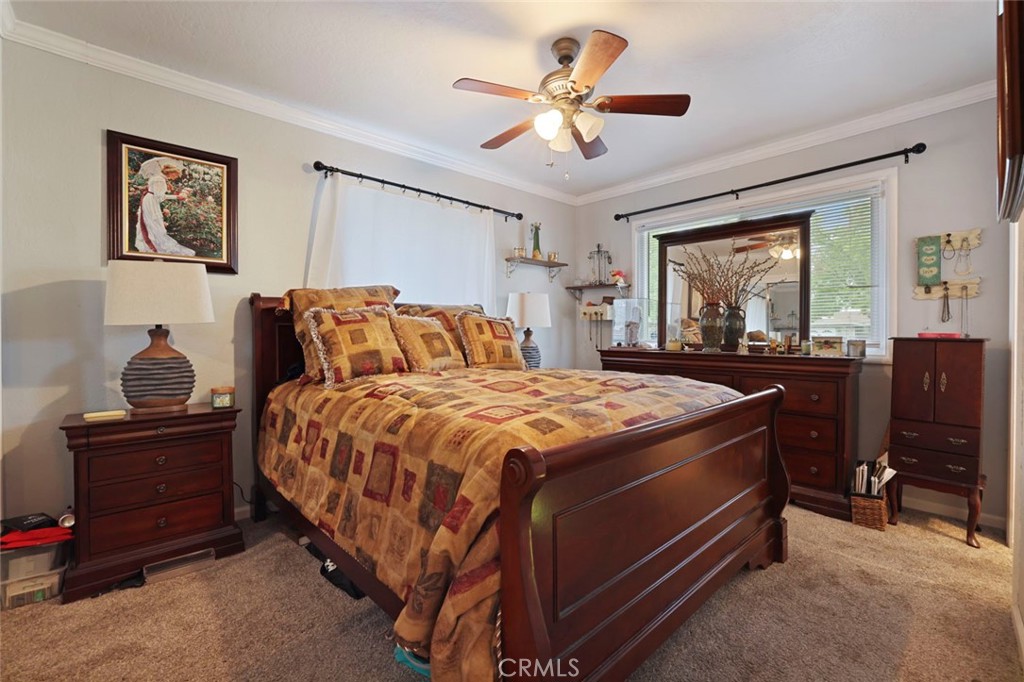 424 Morada Lane Stockton, CA 95210 - Photo 17 of 51 a bedroom with a bed and a chandelier